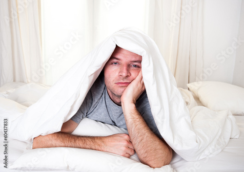 Photo: man in bed with eyes opened suffering insomnia man in bed with eyes opened suffering insomnia