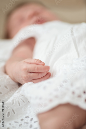 Photo: Defocused hand detail of a sleeping newborn baby girl Defocused hand detail of a sleeping newborn baby girl