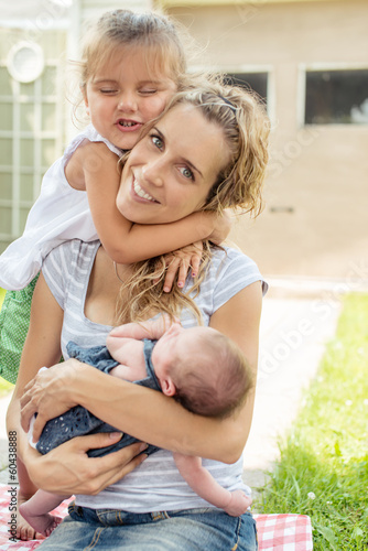 Photo: Mother and two daughters hugging outside Mother and two daughters hugging outside