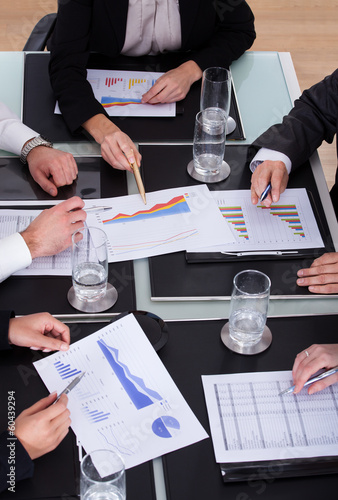 Photo: Group Of Businesspeople Discussing Plan In Office Group Of Businesspeople Discussing Plan In Office