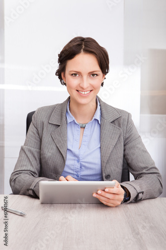 Photo: Businesswoman Holding Digital Tablet Businesswoman Holding Digital Tablet