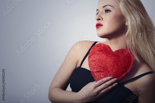 Photo: Lovely Beautiful Blond Woman with Red Heart.Symbol of Valentine Lovely Beautiful Blond Woman with Red Heart.Symbol of Valentine