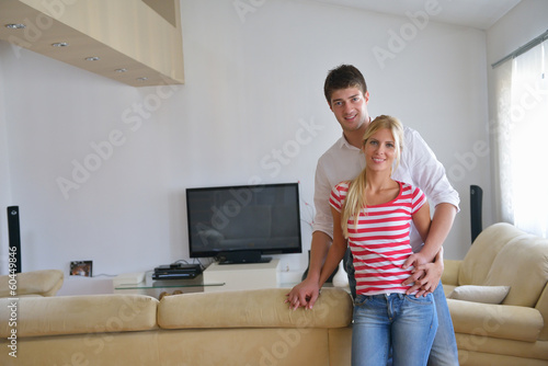 Photo: Relaxed young couple watching tv at home Relaxed young couple watching tv at home