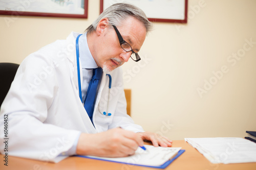 Photo: Doctor writing a prescription Doctor writing a prescription