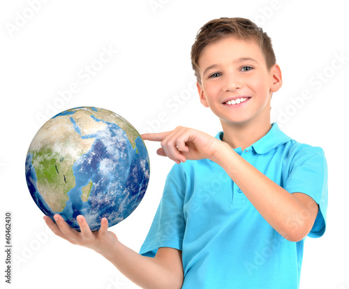 Photo: Smiling boy in casual holding planet earth in hands Smiling boy in casual holding planet earth in hands
