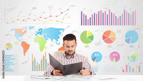 Photo: Business man with colorful charts Business man with colorful charts