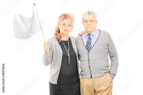 Photo: Middle aged couple waving a white flag Middle aged couple waving a white flag