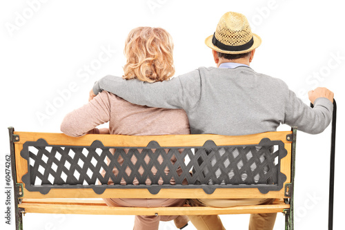Photo: Senior couple sitting on a bench, rear view Senior couple sitting on a bench, rear view