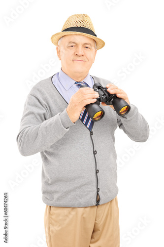 Photo: Senior gentleman holding binoculars and looking at camera Senior gentleman holding binoculars and looking at camera