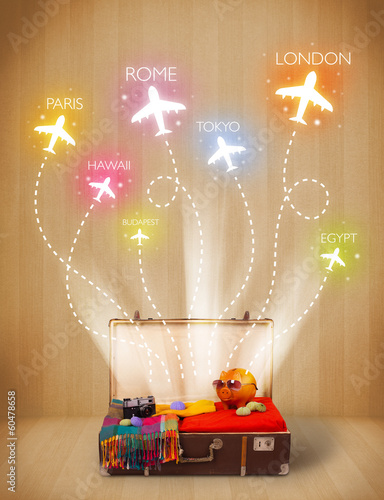 Photo: Travel bag with clothes and colorful planes flying out Travel bag with clothes and colorful planes flying out