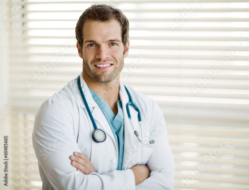 Photo: Confident Male Doctor With Arms Crossed Confident Male Doctor With Arms Crossed