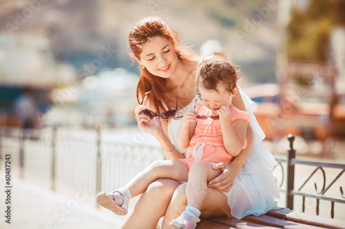 Photo: Portrait of a young mother and baby having fun on the waterfront Portrait of a young mother and baby having fun on the waterfront