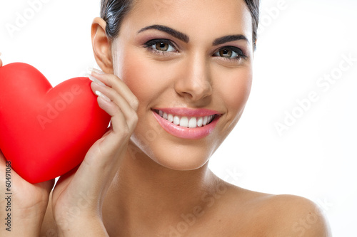 Photo: Smiling woman with red heart Smiling woman with red heart
