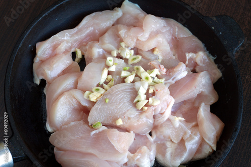 Photo: Sliced chicken meat with spice and garlic inside pan in process Sliced chicken meat with spice and garlic inside pan in process