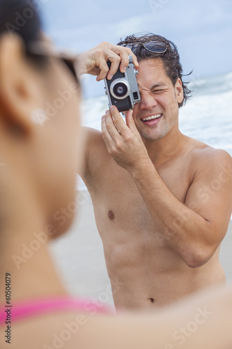Photo: Couple at Beach Taking Photographs Couple at Beach Taking Photographs
