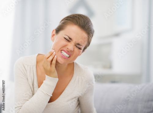 Photo: Portrait of young woman with toothache Portrait of young woman with toothache