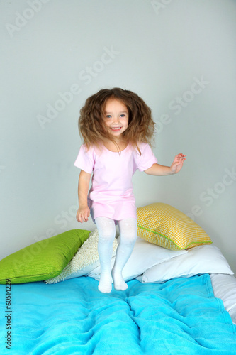Photo: Little girl jumping on bed Little girl jumping on bed