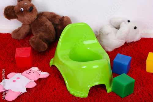 Photo: Green potty on home interior background Green potty on home interior background