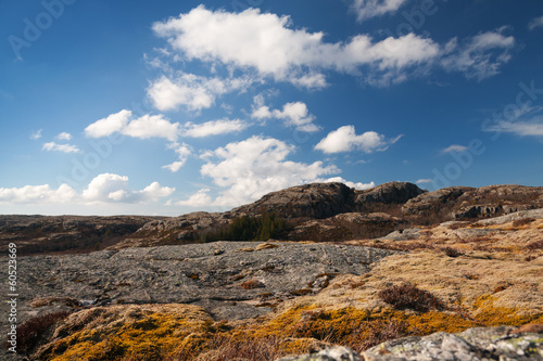Photo: Norwegian mountain landscape with deep blue cloudy sky Norwegian mountain landscape with deep blue cloudy sky