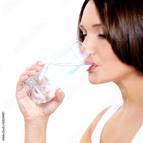 Photo: Young smiling woman holds glass of water Young smiling woman holds glass of water