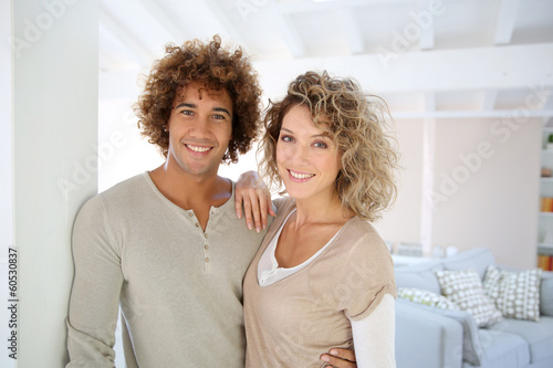 Photo: Attractive smiling couple in new home Attractive smiling couple in new home