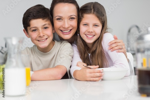 Photo: Closeup of a smiling mother with young in kitchen Closeup of a smiling mother with young in kitchen