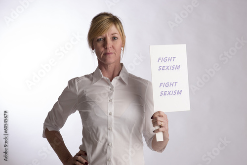 Photo: Mature female protester holding Fight Sexism poster Mature female protester holding Fight Sexism poster
