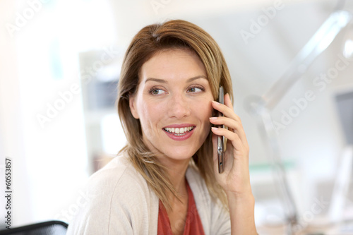Photo: Portrait of confident businesswoman talking on the phone Portrait of confident businesswoman talking on the phone