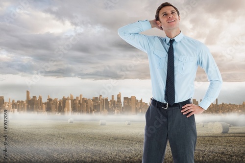 Photo: Composite image of thinking businessman with hand on head Composite image of thinking businessman with hand on head
