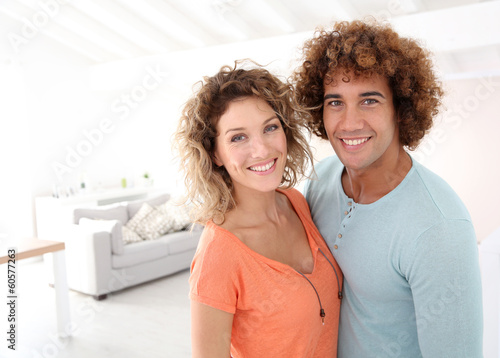 Photo: Cheerful couple standing in their new place Cheerful couple standing in their new place