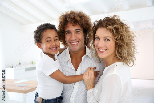 Photo: Happy family standing in brand new home Happy family standing in brand new home
