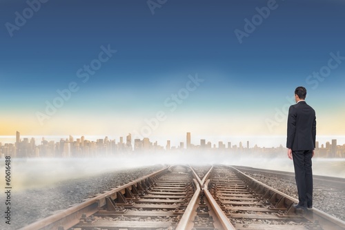 Photo: Composite image of businessman turning his back to camera Composite image of businessman turning his back to camera