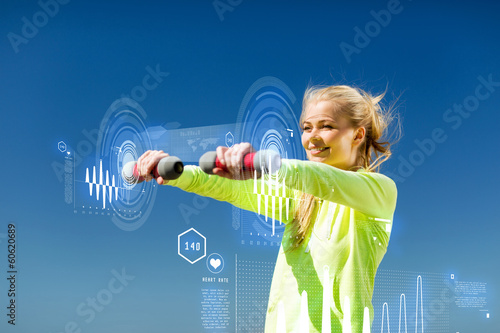 Photo: sporty woman with light dumbbells outdoors sporty woman with light dumbbells outdoors