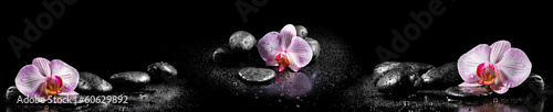 Fototapeta Horizontal panorama with pink orchids and zen stones on black ba