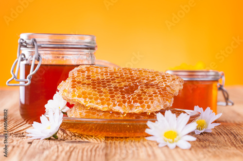 Photo: Honey in jar with honeycomb Honey in jar with honeycomb
