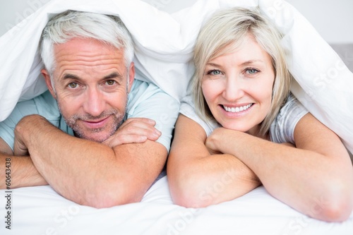 Photo: Closeup of a mature couple lying in bed Closeup of a mature couple lying in bed