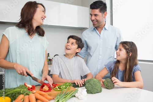 Photo: Family chopping vegetables in the kitchen Family chopping vegetables in the kitchen