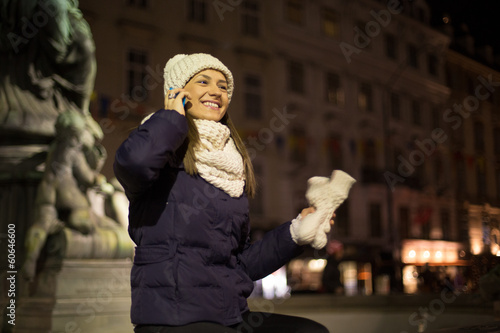 Photo: Young woman at night with mobile phone Young woman at night with mobile phone