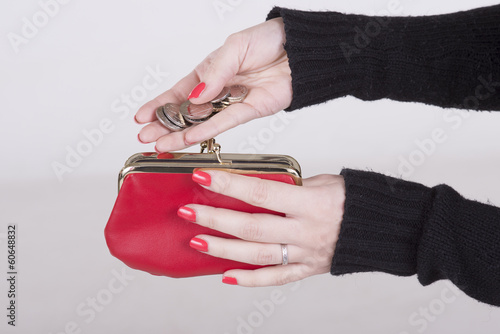 Photo: Woman holding money and a red purse Woman holding money and a red purse