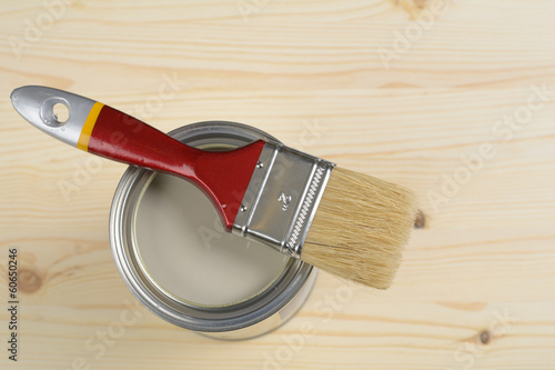 Photo: Paintbrush and a can with paint Paintbrush and a can with paint