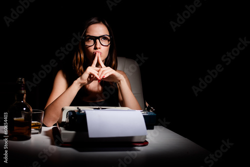 Photo: Pensive writer working on her book Pensive writer working on her book