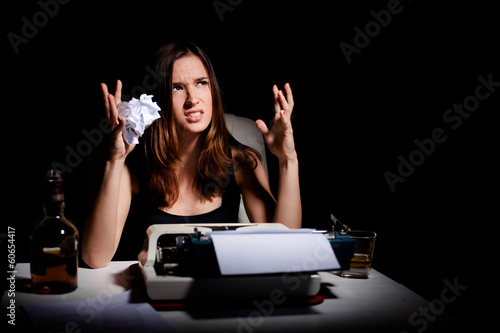 Photo: Frustrated young writer having writer's block Frustrated young writer having writer's block