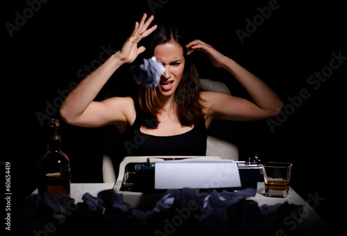 Photo: Novelist throwing wrinkled paper because of writer's block Novelist throwing wrinkled paper because of writer's block