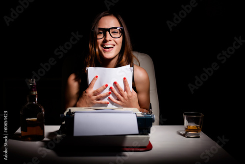 Photo: Young female novelist is happy because she finished writing her Young female novelist is happy because she finished writing her