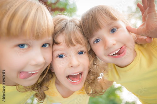 Photo: Low angle view portrait of happy children Low angle view portrait of happy children