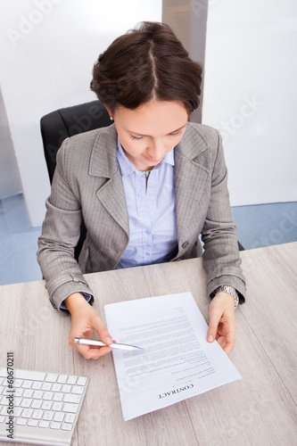 Photo: Businesswoman Holding Contract Paper Businesswoman Holding Contract Paper