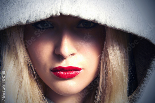 Photo: Beautiful Blond Woman in Hood.Red Lips.Box.Close-up Beautiful Blond Woman in Hood.Red Lips.Box.Close-up
