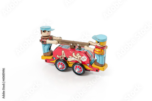 Photo: Vintage old tin toy made of tin isolated on white.clipping path Vintage old tin toy made of tin isolated on white.clipping path