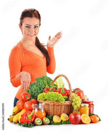 Photo: Young woman with assorted vegetables isolated on white Young woman with assorted vegetables isolated on white