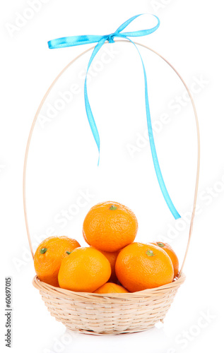 Photo: Ripe sweet tangerines in wicker basket, isolated on white Ripe sweet tangerines in wicker basket, isolated on white